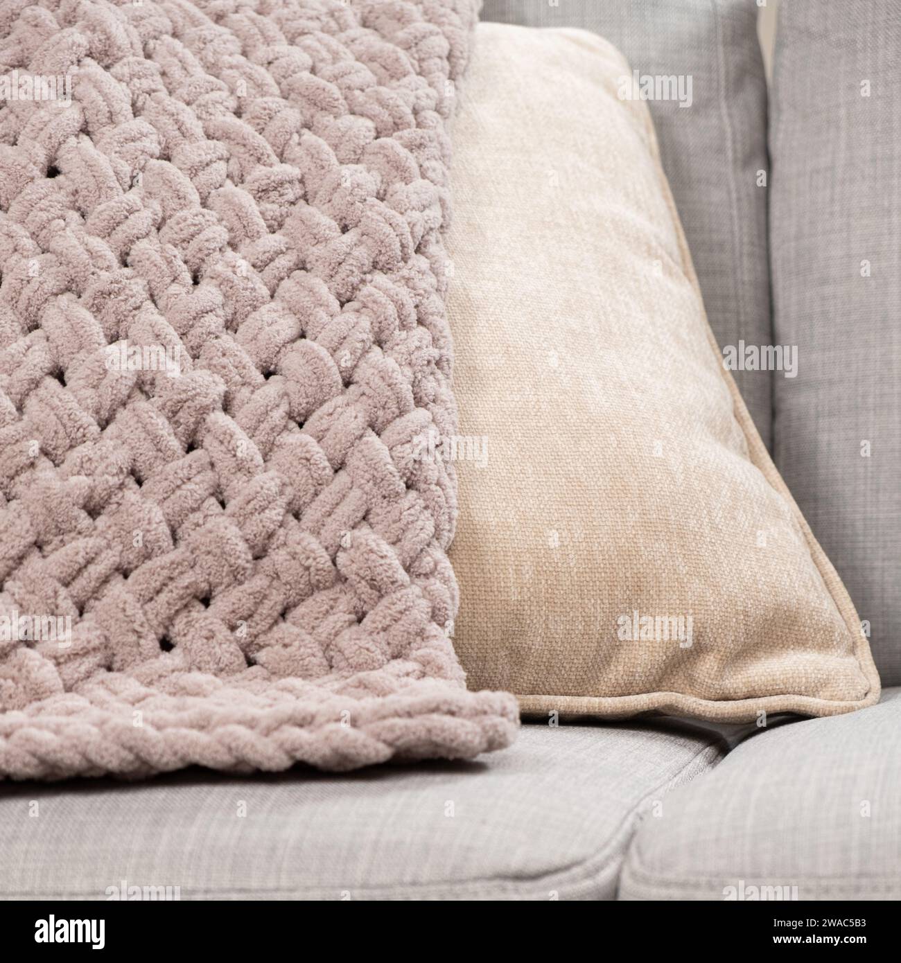 Knitted light pink plaid handmade close-up. Stock Photo