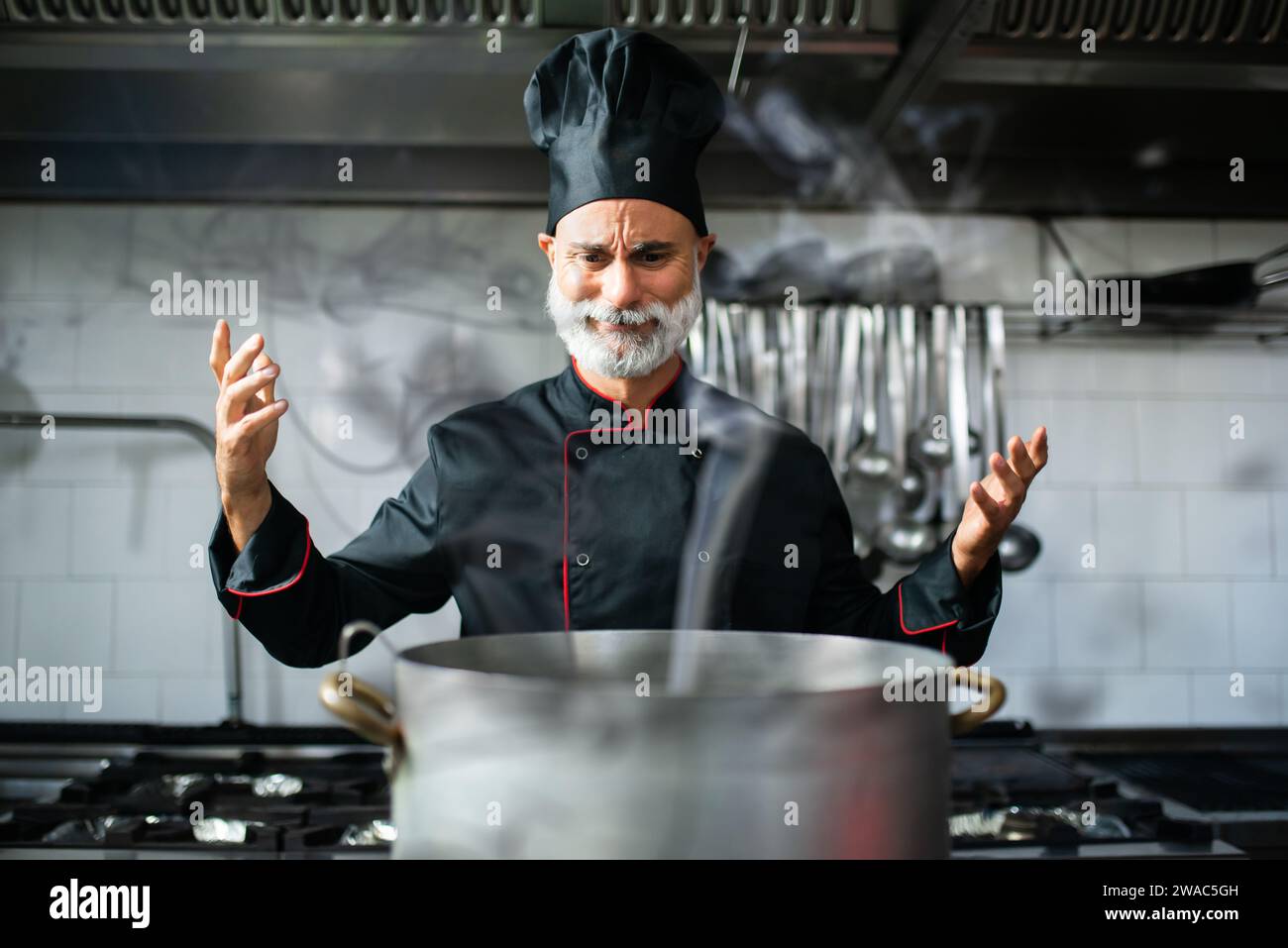 Clumsy chef doing disasters while cooking Stock Photo