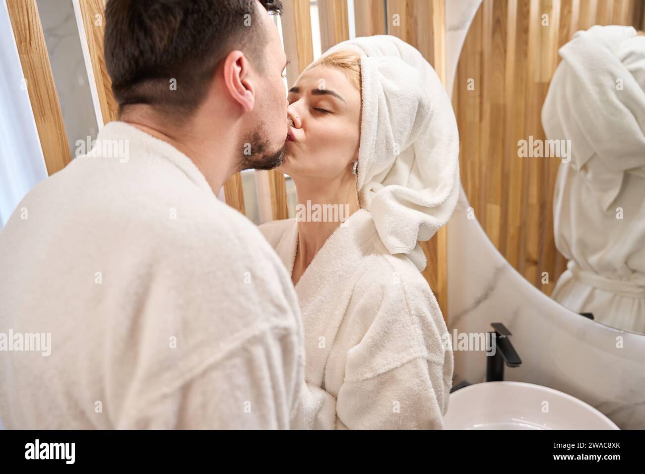 Man kissing woman in bathroom hi-res stock photography and images - Alamy