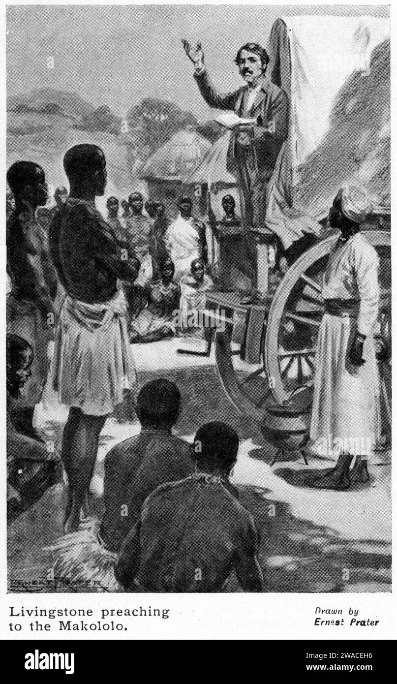 missionary David Livingstone stands in the back of a covered wagon while preaching from his Bible to the Makololo people in Africa Stock Photo