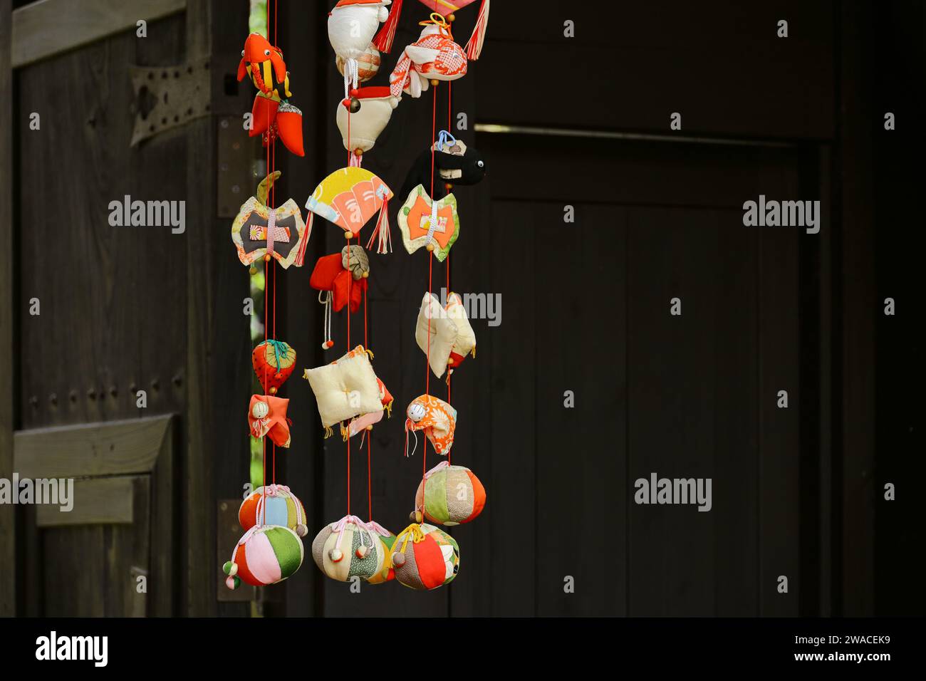 Japanese scenery  Hanging ornamental dolls in front of the gate decorated for the Doll's Festival called "Hina Matsuri", which is a festival to pray f Stock Photo