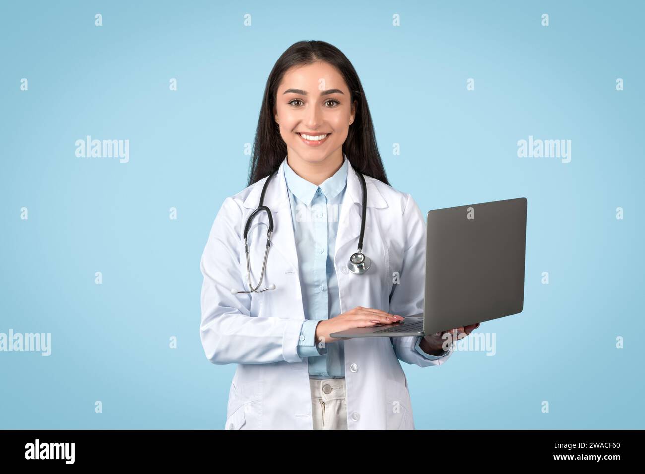 Happy female doctor with laptop, modern telemedicine concept Stock Photo