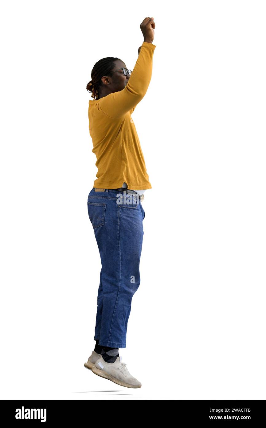 A man in a yellow jacket jumps on a White background, in profile Stock Photo