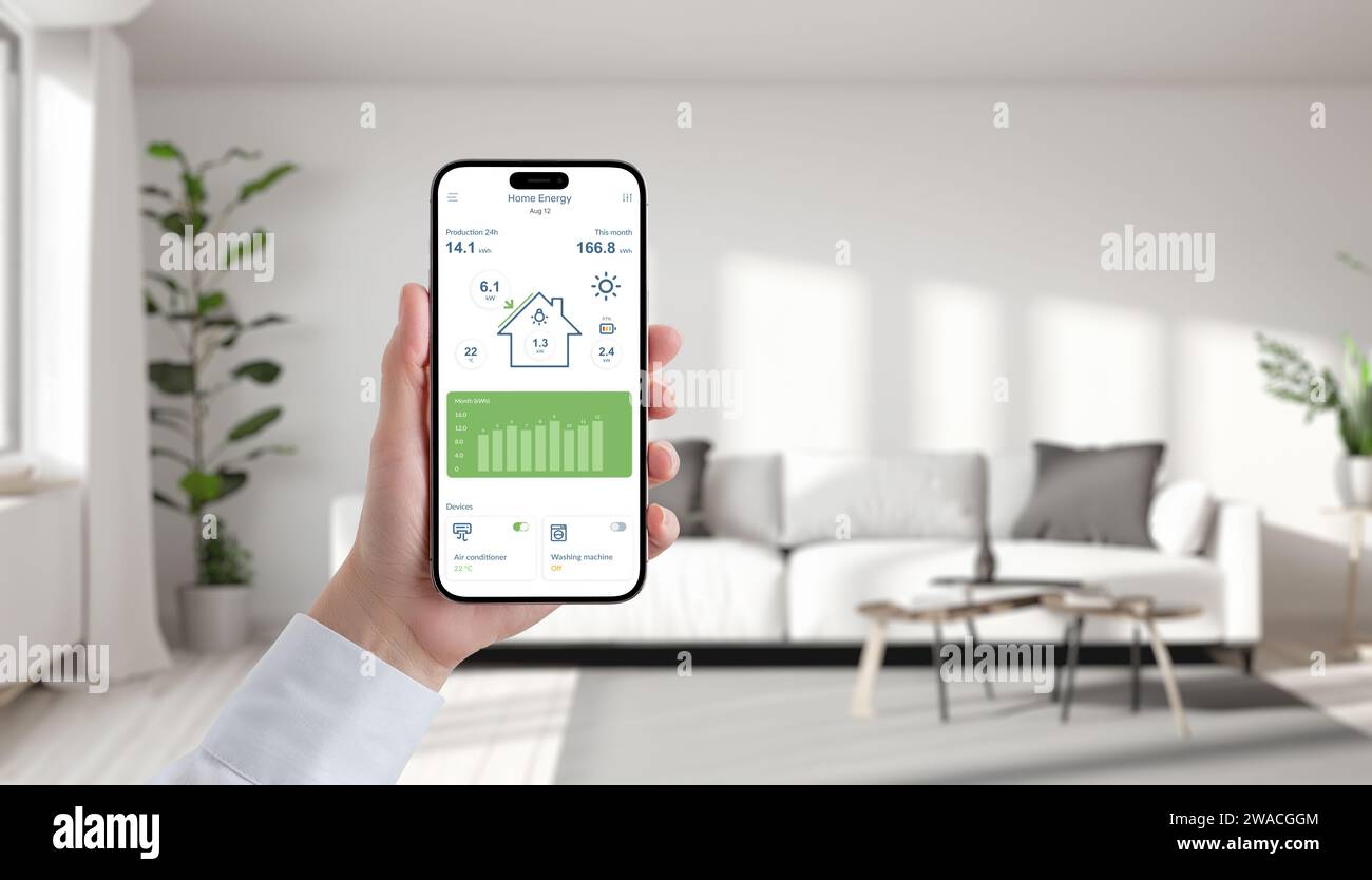 Hand holds phone displaying solar energy app in a cozy living room, effortlessly manage and monitor green power for sustainable living Stock Photo
