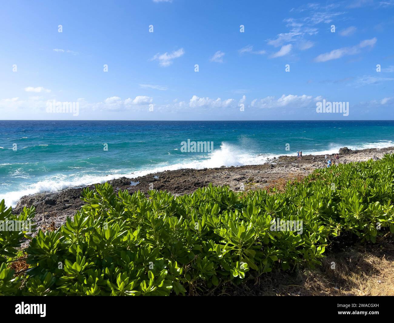 Cayman Islands - January 25, 2023: Tourists looking over the clear blue
