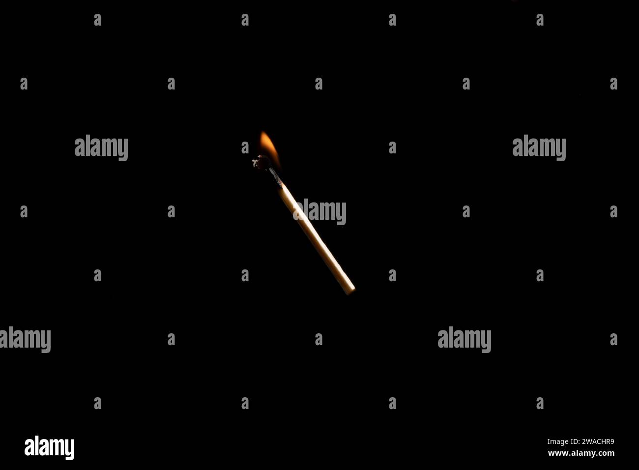 Lit and falling match on a black background. Stock Photo