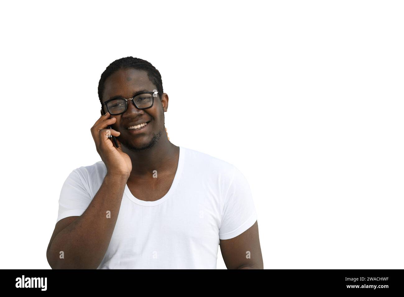 A man in a white T-shirt on a White background talks on the phone Stock Photo