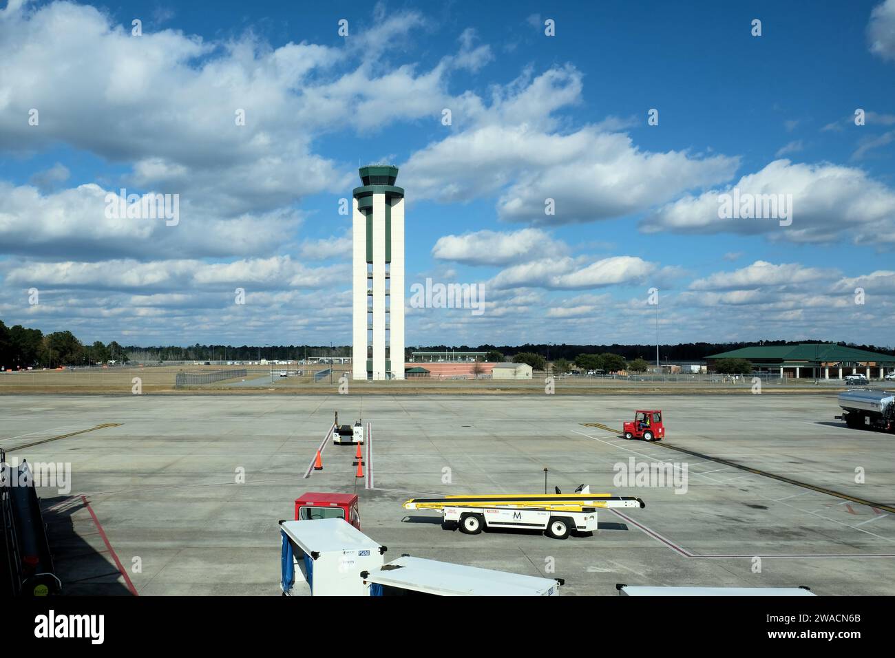 Air traffic control tower with service vehicles on jetway and tarmac at Savannah-Hilton Head Airport in Savannah, Georgia, USA. Stock Photo
