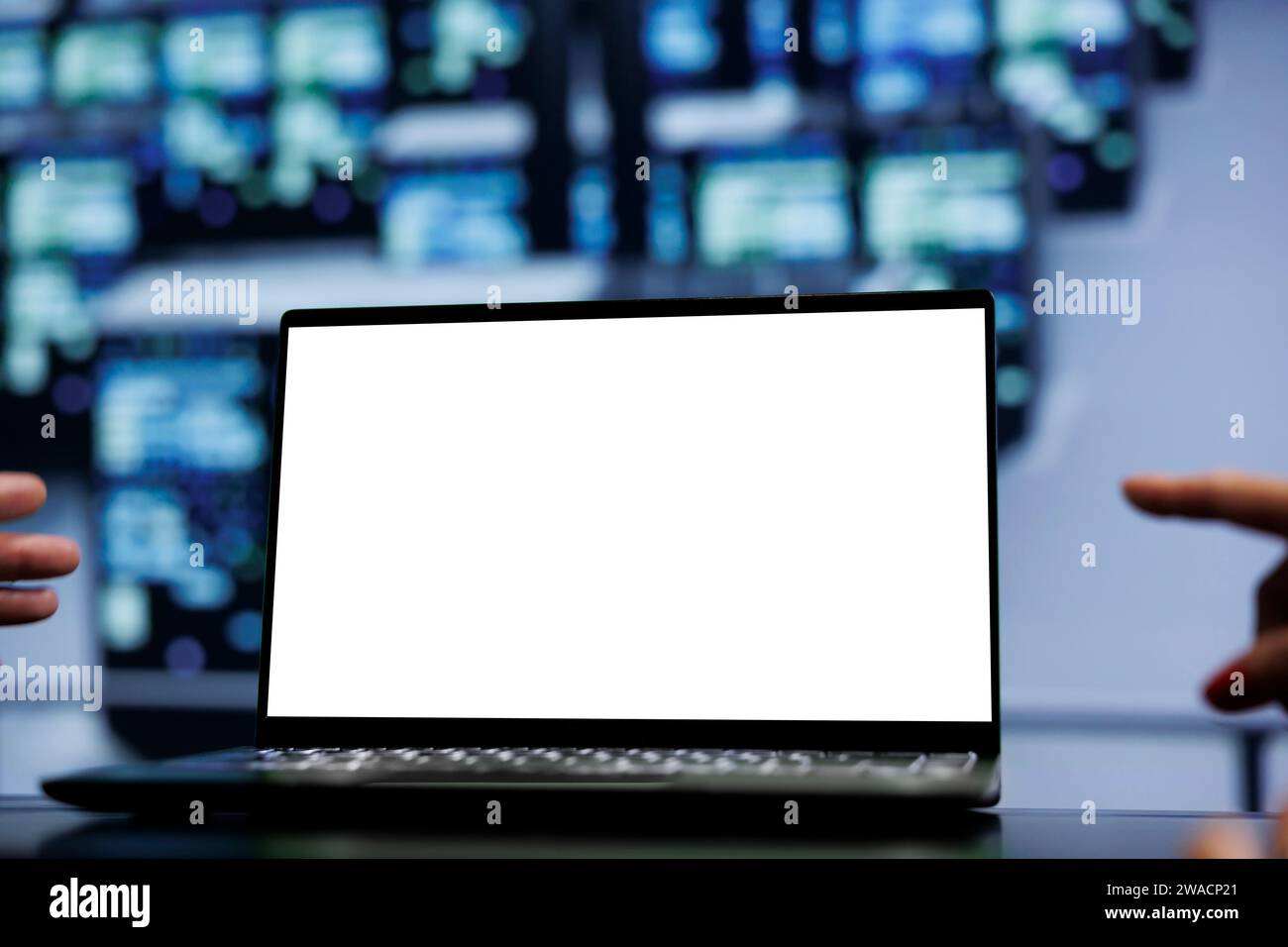 Teamworking colleagues using mock up laptop to check supercomputers, close up. Infrastructure in computer network security server farm providing processing and memory resources for several workloads Stock Photo