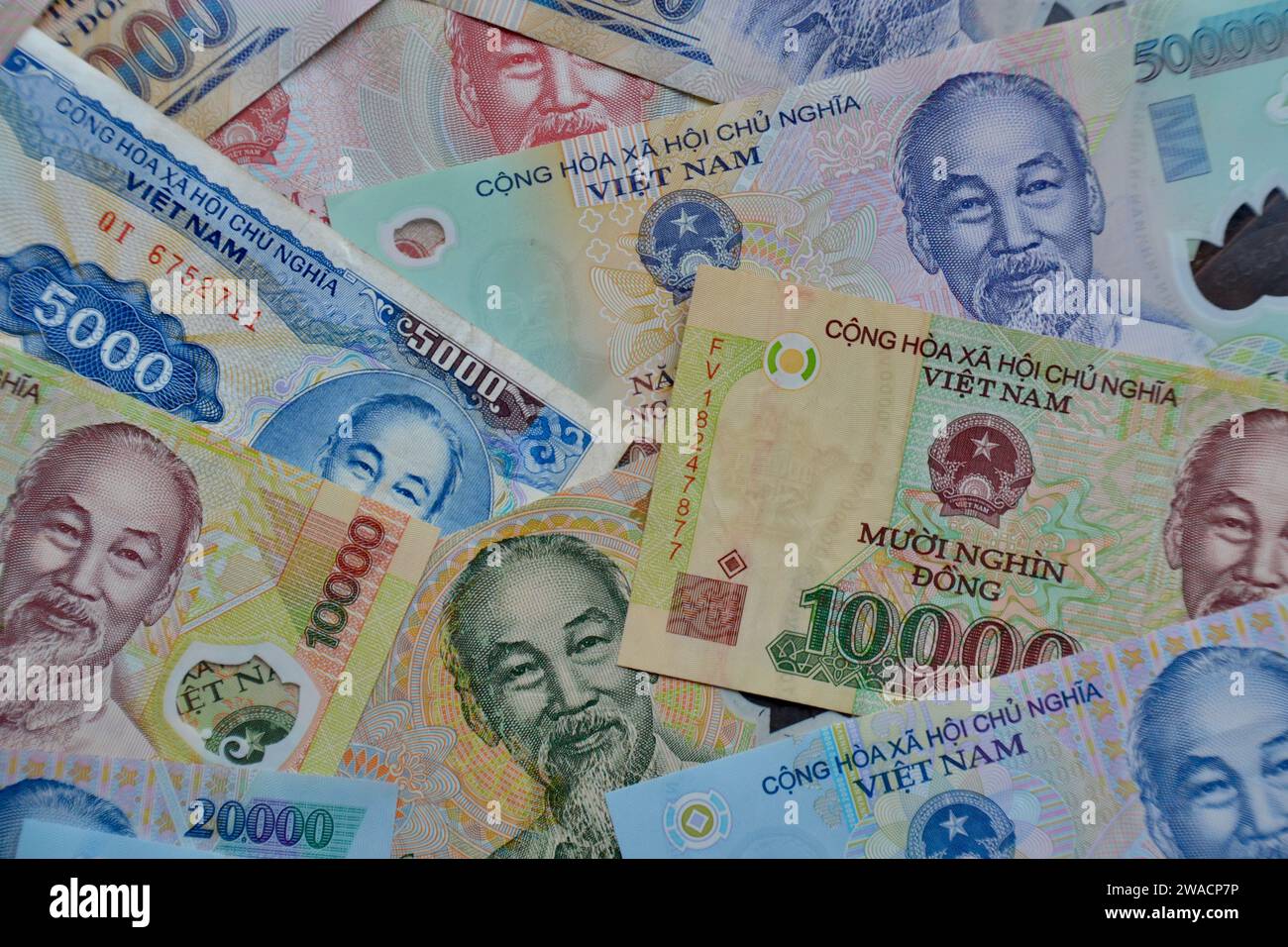 Many bank notes laid out flat in a collage a high denomination Vietnamese Dong as a concept for wealth, finance and business Stock Photo