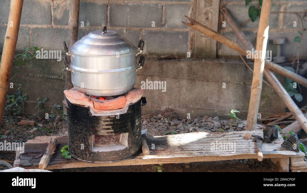 Aluminium steamer on fire wood charcoal stove Stock Photo Alamy