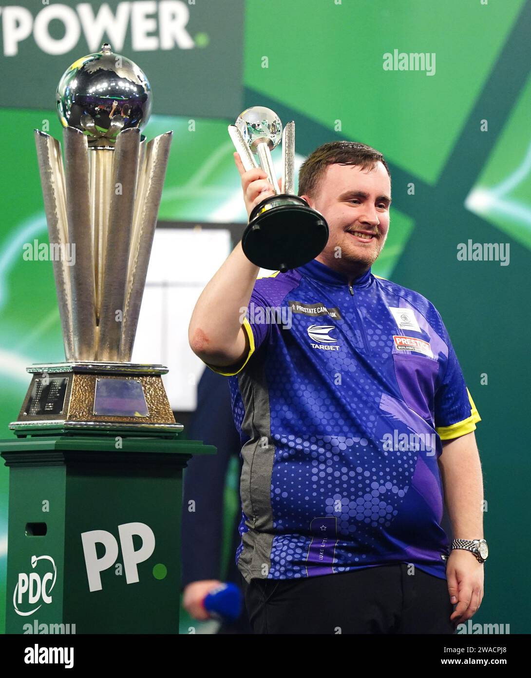 Luke Littler celebrates with his runners up trophy after being beaten by Luke Humphries in the