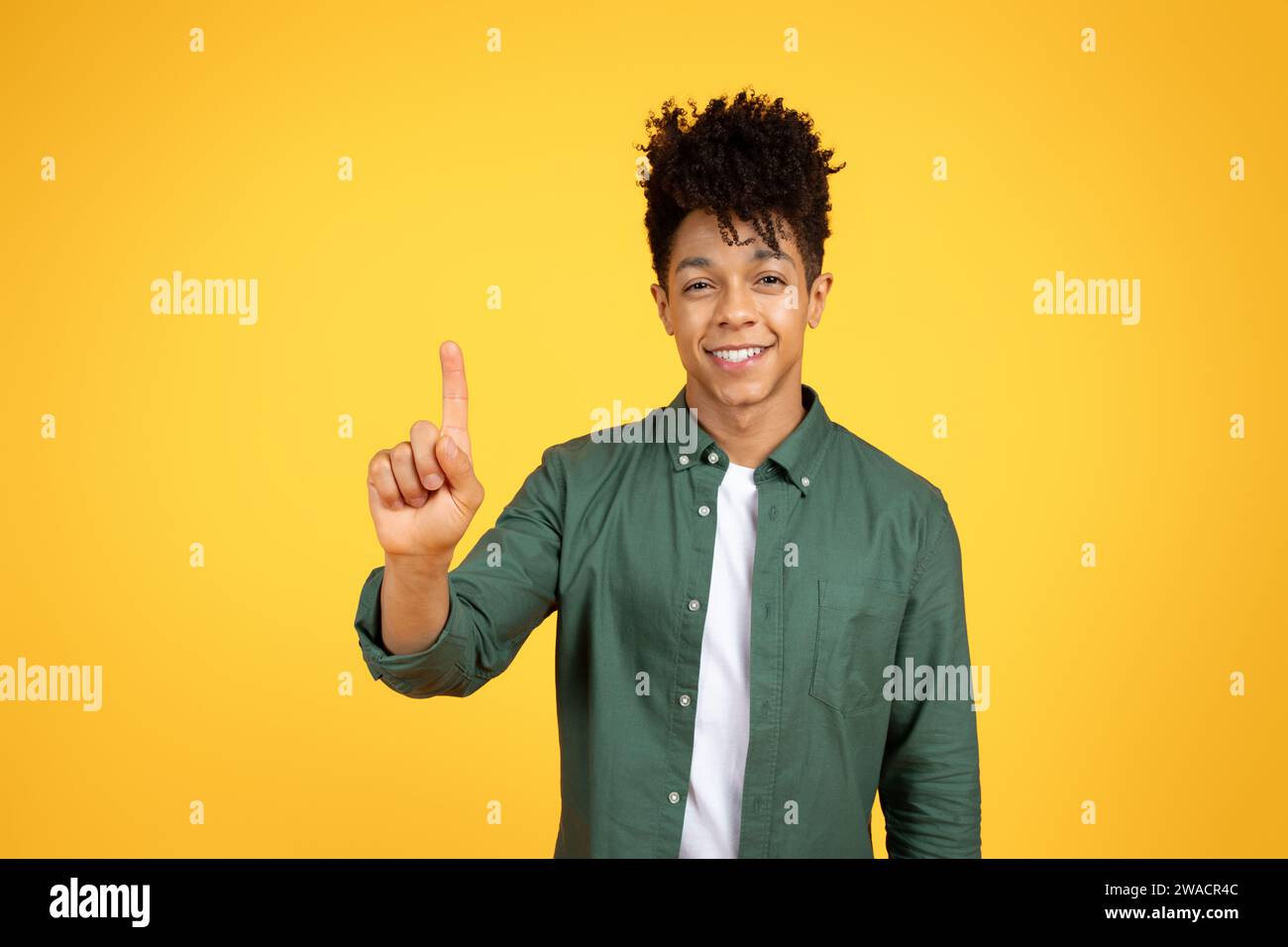 Excited Black Guy Touching Invisible Screen Or Pushing Button Stock Photo