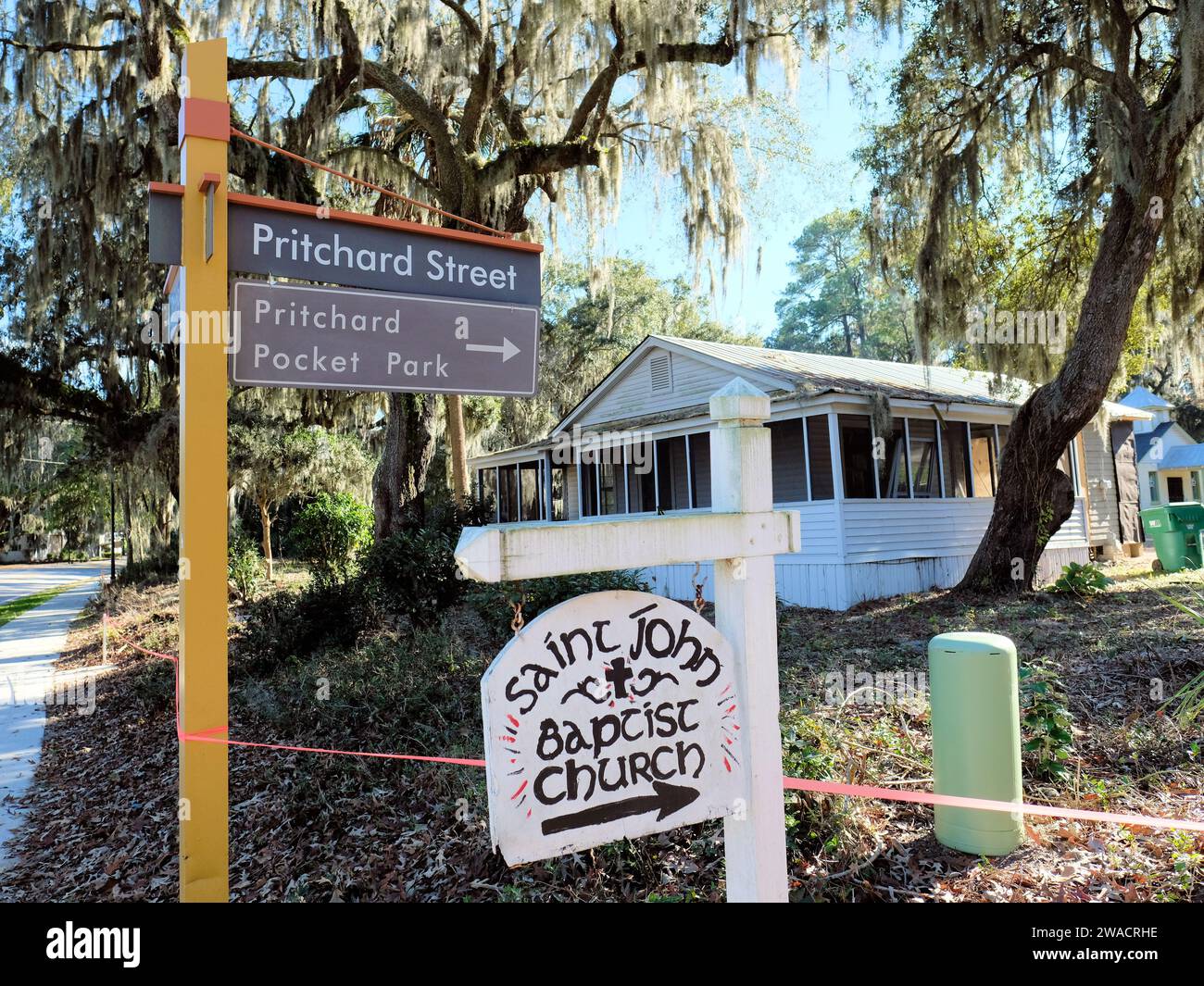 Pritchard Street and Pritchard Pocket Park signs with a hand painted sign pointing towards Saint John Baptist Church in Bluffton, South Carolina. Stock Photo