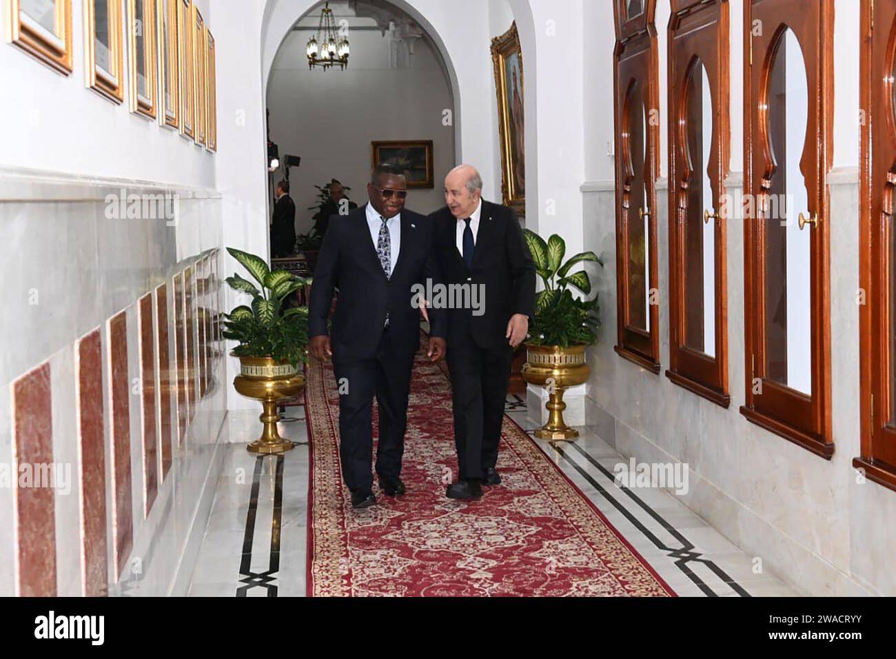 (240103) -- ALGIERS, Jan. 3, 2024 (Xinhua) -- Algerian President Abdelmadjid Tebboune (R) welcomes Sierra Leonean President Julius Maada Bio (L) in Algiers, Algeria, on Jan. 3, 2024. Algeria and Sierra Leone affirmed on Wednesday their commitment to closely collaborate in upholding international peace and security in accordance with the UN Charter and international law. (Algerian Presidency/Handout via Xinhua) Stock Photo