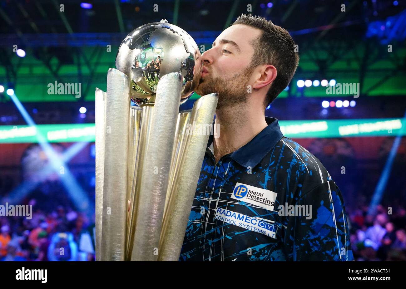 Luke Humphries celebrates with the trophy after winning the final of
