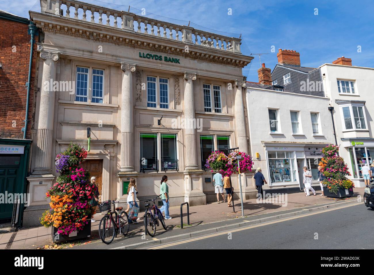 Lloyds bank, branch of Lloyds bank on the high street in Sidmouth,Devon,England, sunny autumn day with flowering hanging baskets,England,2023 Stock Photo