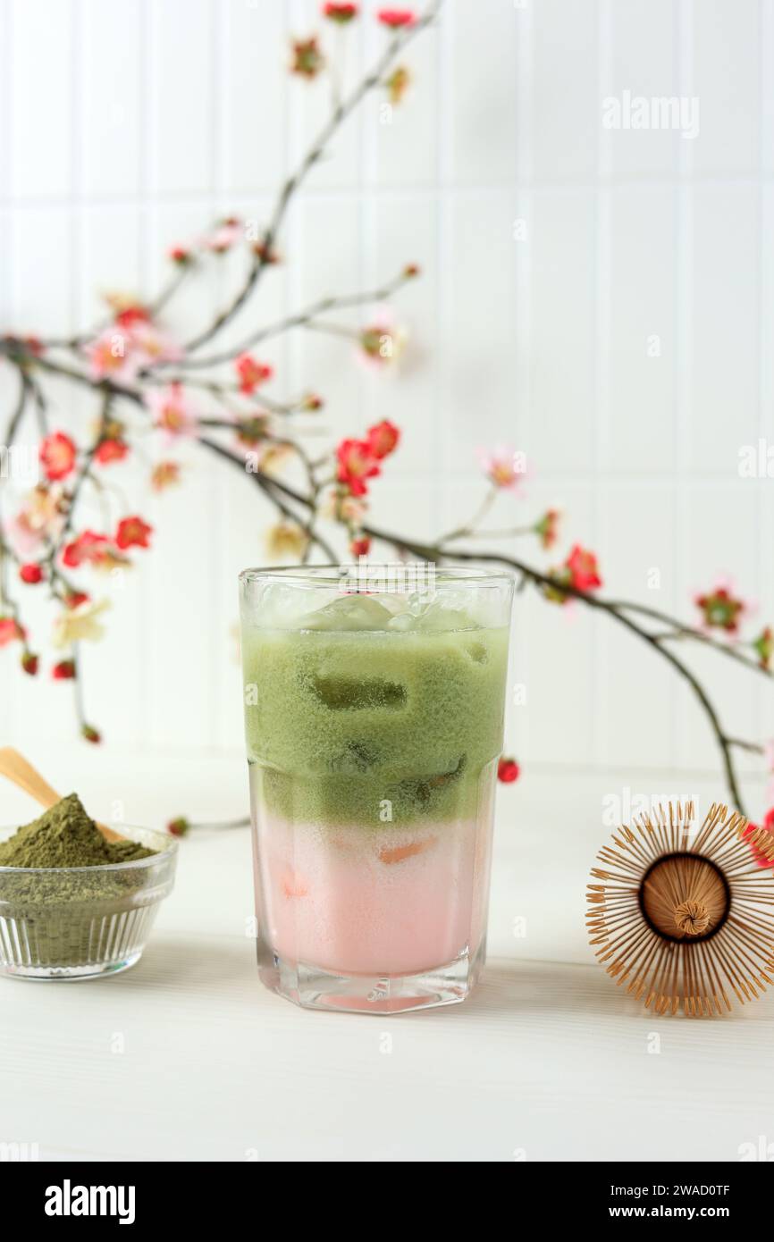 Iced Sakura Green Tea Milk on White Table Stock Photo