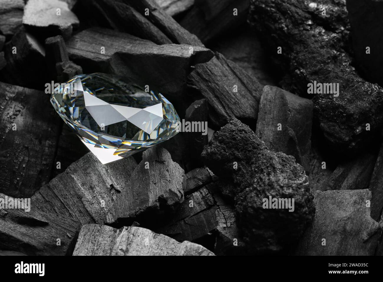 Beautiful shiny diamond on coal, closeup view Stock Photo