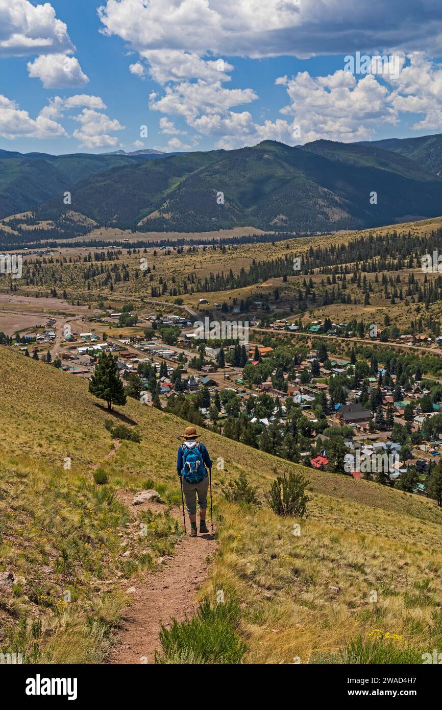 USA, Colorado, Creede, Rear view of woman hiking near town Stock Photo