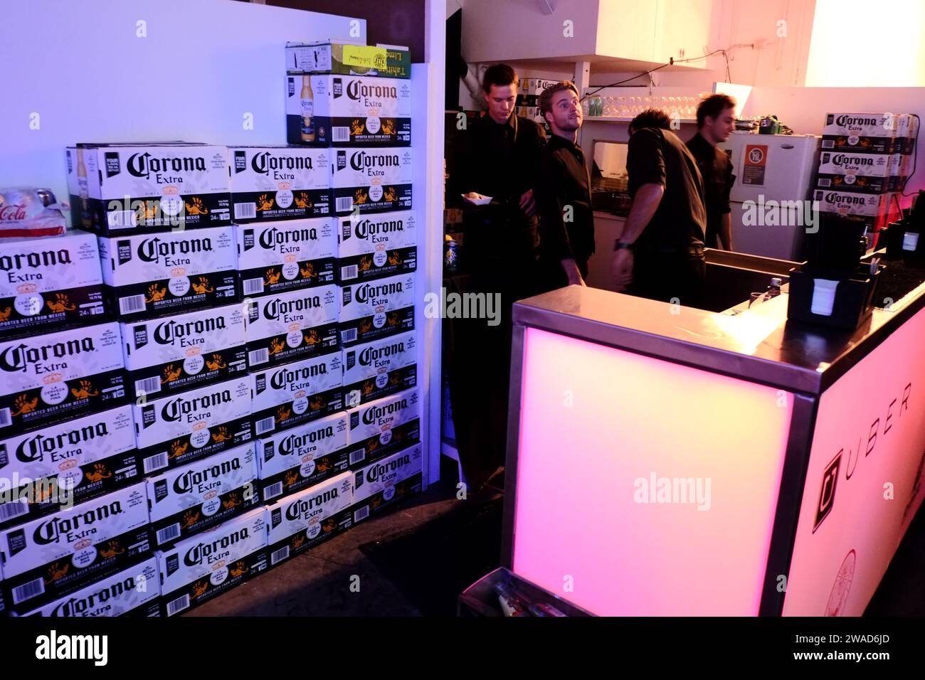 A wall of Corona Beer cartons ready for a Sydney art opening event and warehouse dance party sponsored by a marketing agency & several barmen Stock Photo