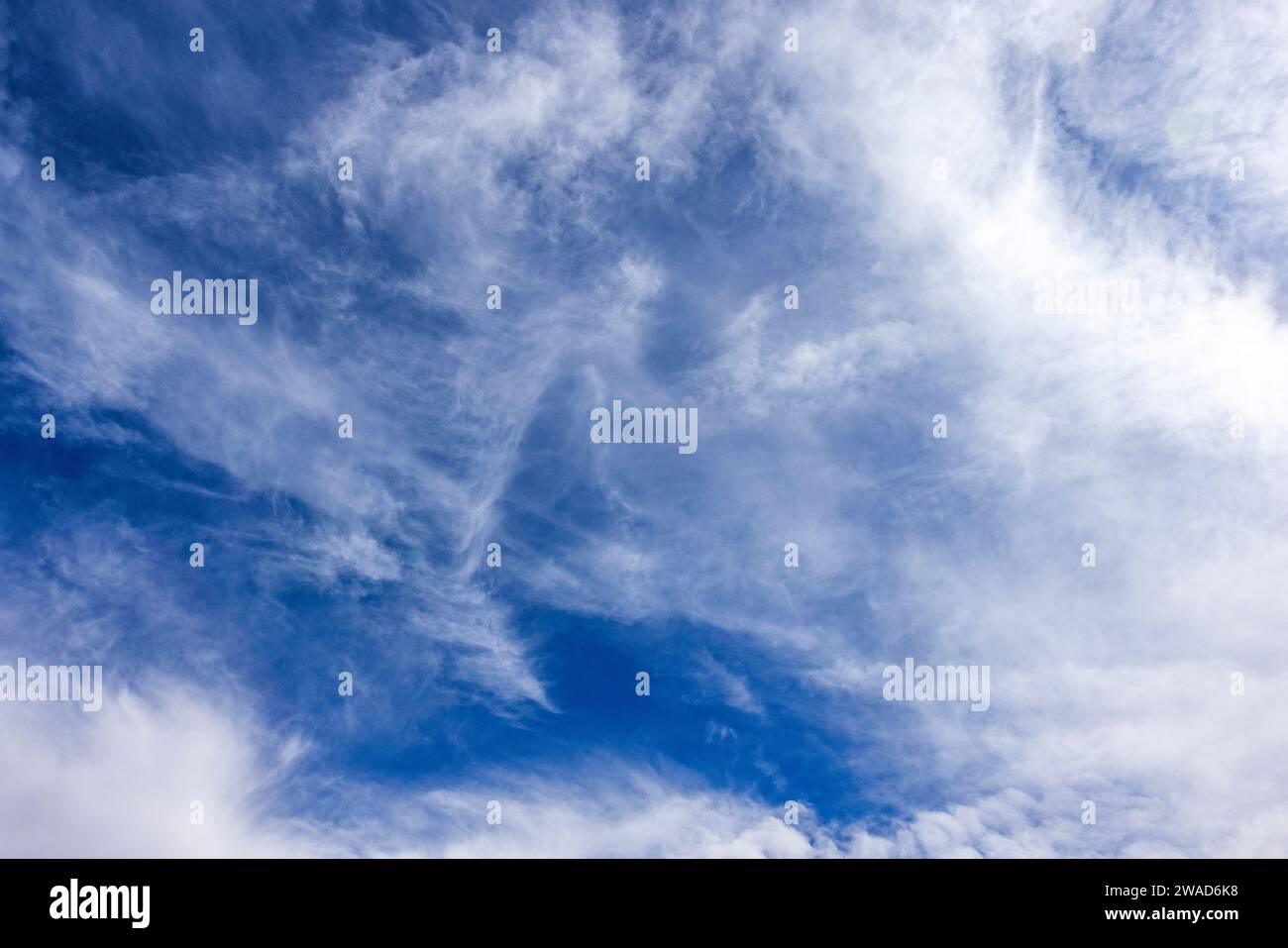 Wispy white clouds in blue sky Stock Photo