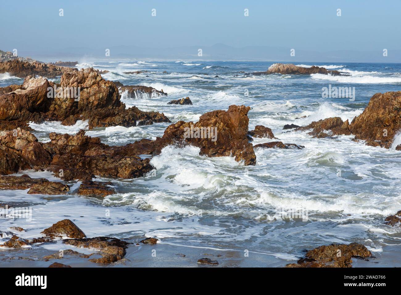 South Africa, Hermanus, Rocky coastline and sea at Kammabaai Beach Stock Photo