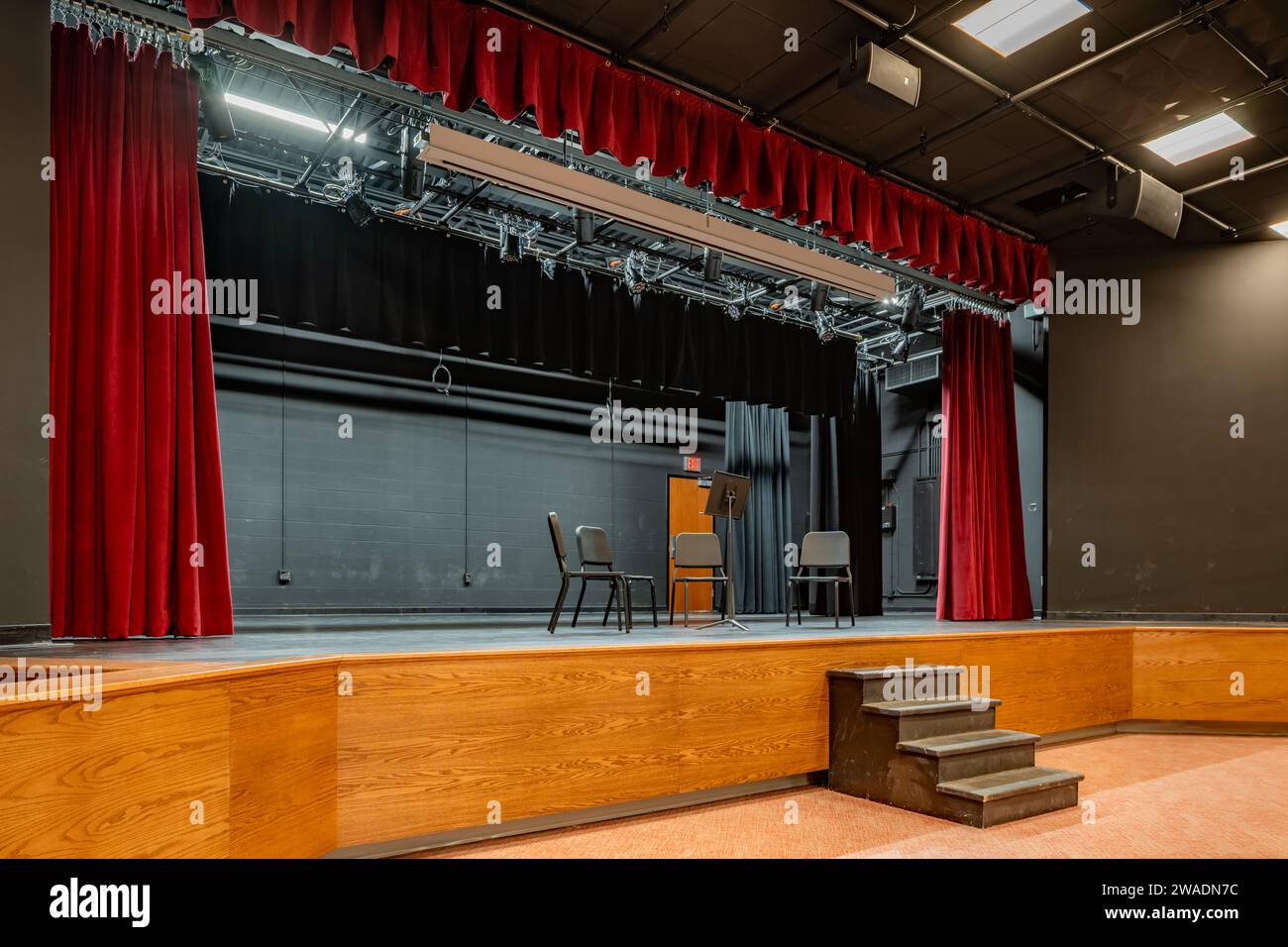 Photo of a new school stage, theater, auditorium, with gray seats, chairs. Stock Photo