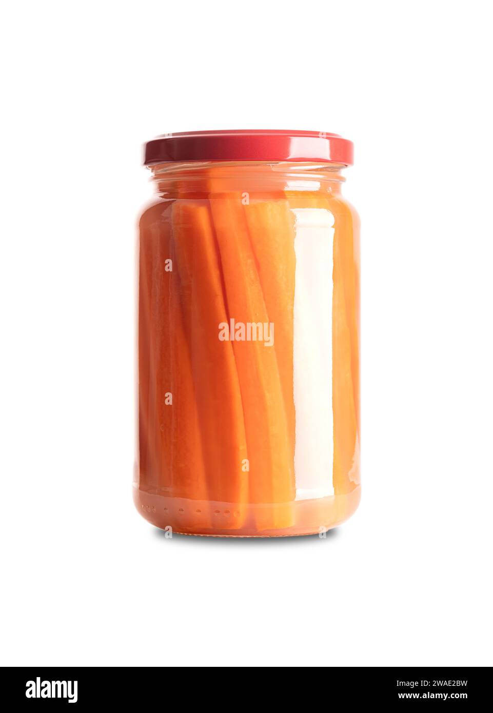 Carrot sticks, homemade fermented carrots, in glass jar with lid. Carrots cut into sticks, fermented by lactic acid bacteria. Stock Photo
