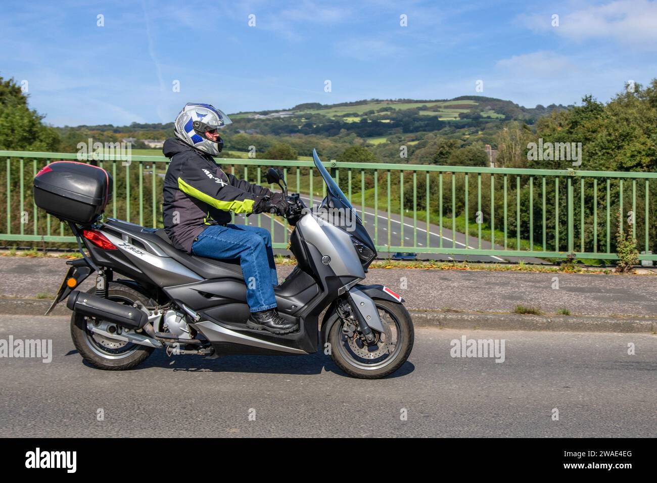2018 Grey Yamaha X-Max 125 Abs Single EU4 Motorcycle Maxi Scooter Petrol 124 cc premium learner friendly maxi scooter, 125cc, EU4-compliant engine bike; crossing motorway bridge in Greater Manchester, UK Stock Photo