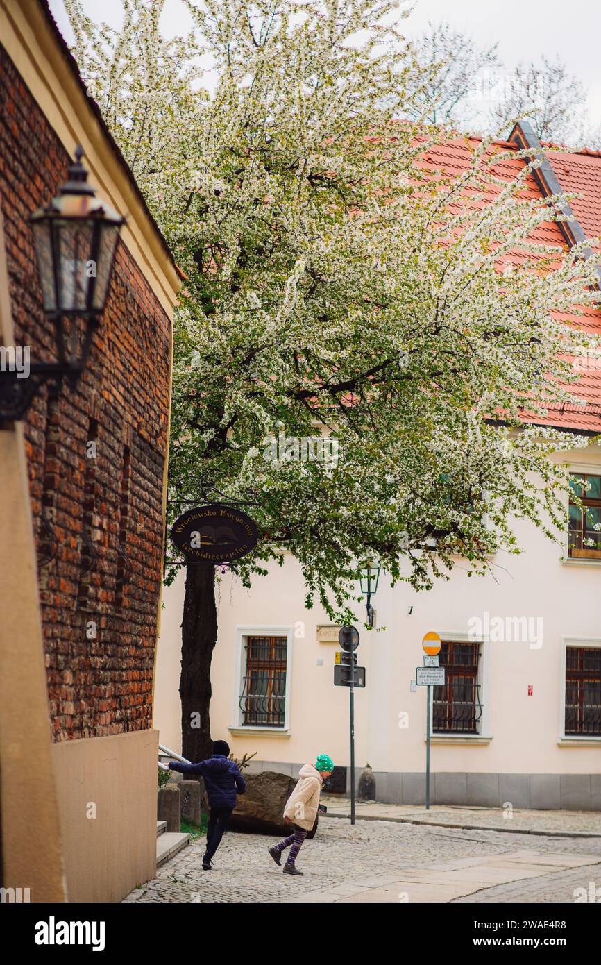 An old street in Wroclaw with children playing Stock Photo