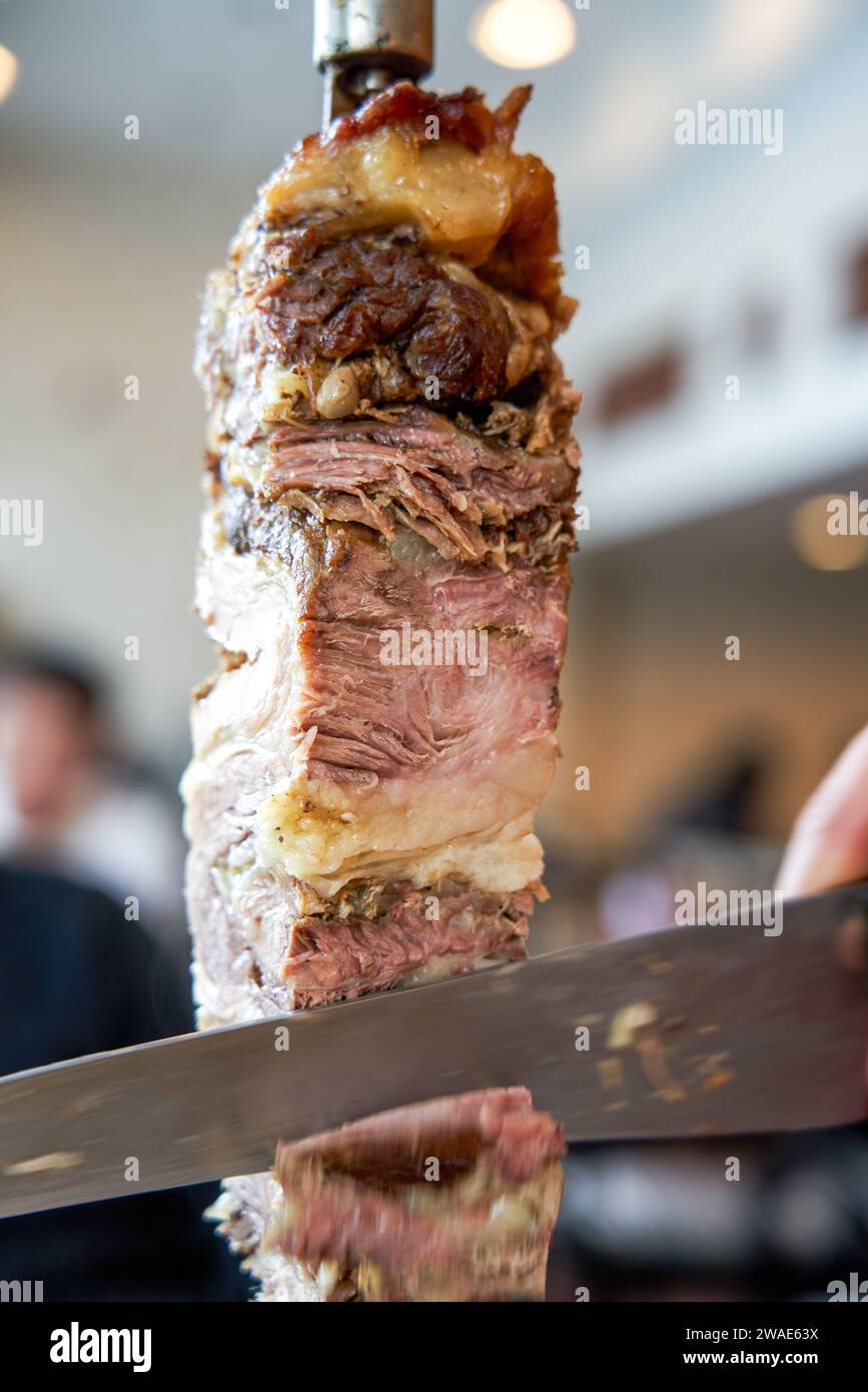 Delicious Brazilian barbecue, big meat skewers Stock Photo