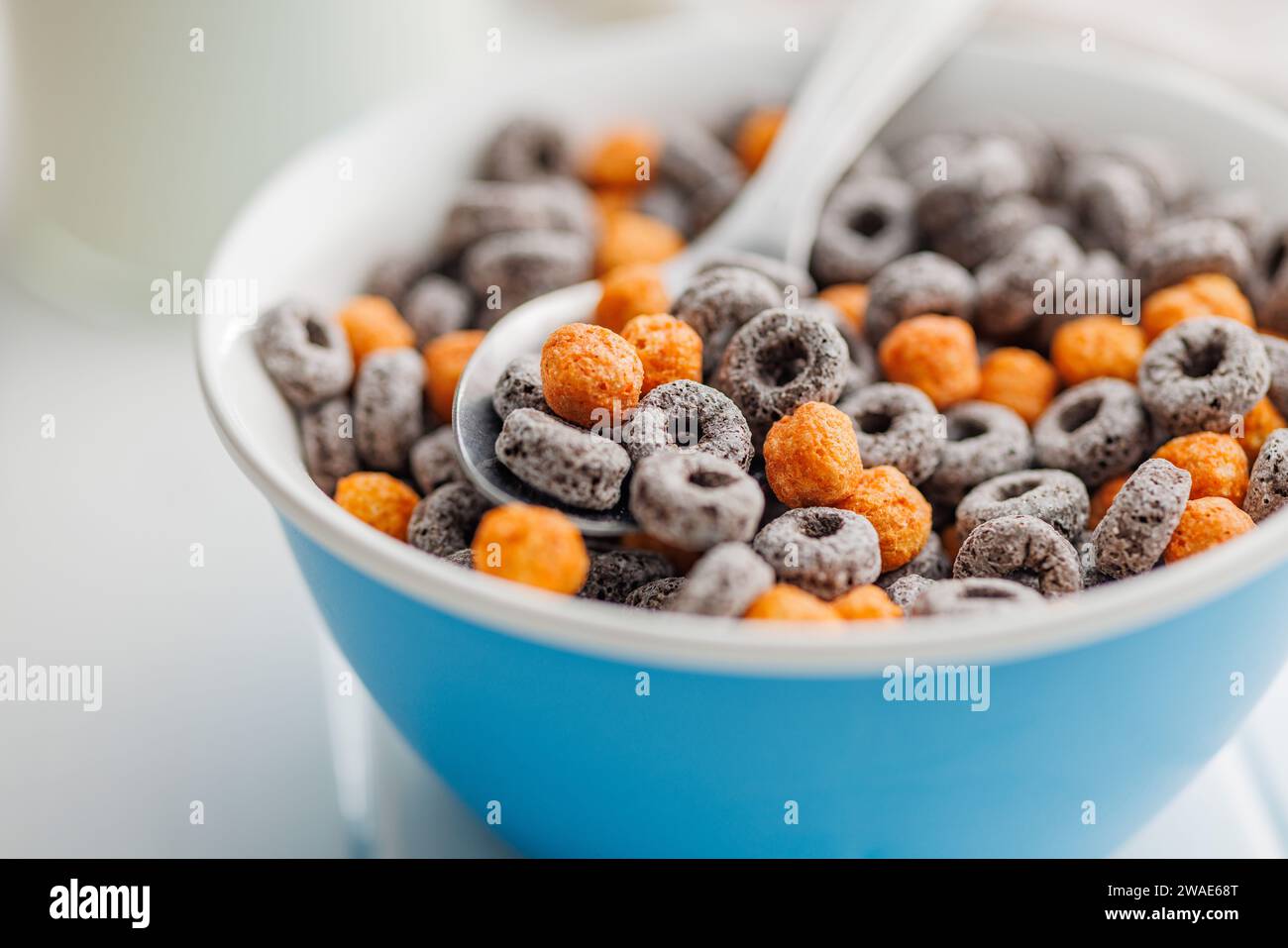 Sweet breakfast cereals in bowl on the white table. Stock Photo