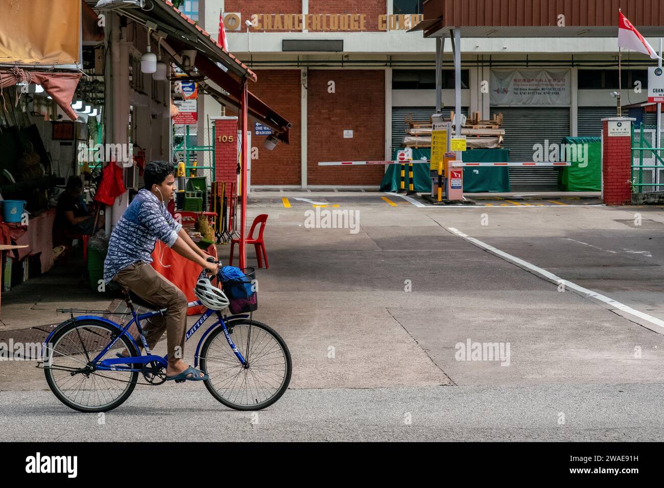 A familiar sight of foreign workers cycling leisurely on Sunday in Geylang, Singapore. Copy Space. Stock Photo