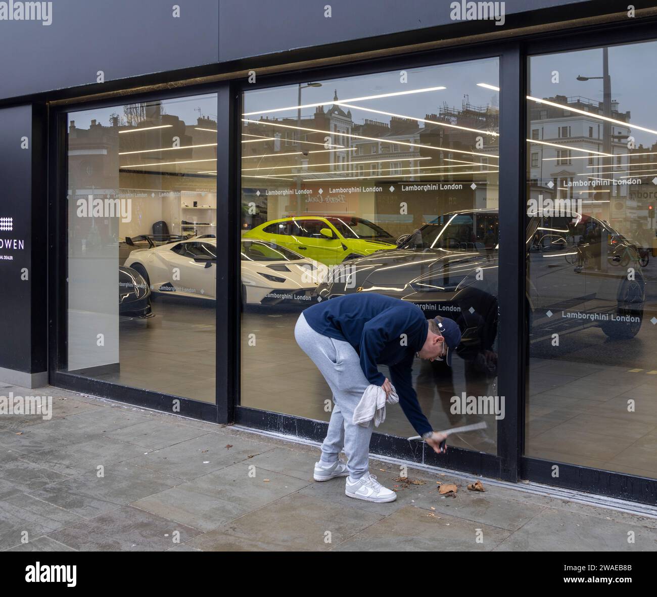 window cleaner at work on Lamborghini showroom, London, UK Stock Photo