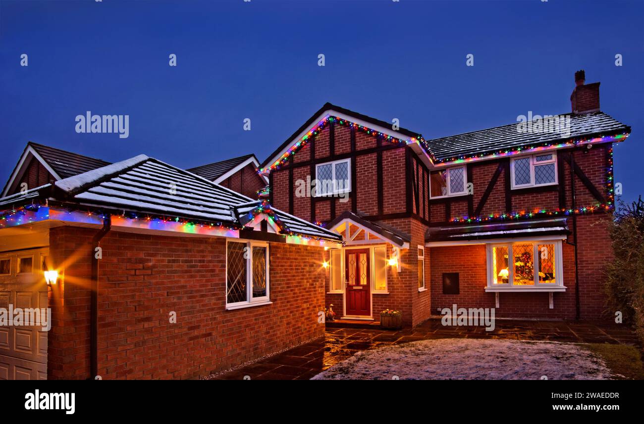 House with Christmas lights and snow. Stock Photo