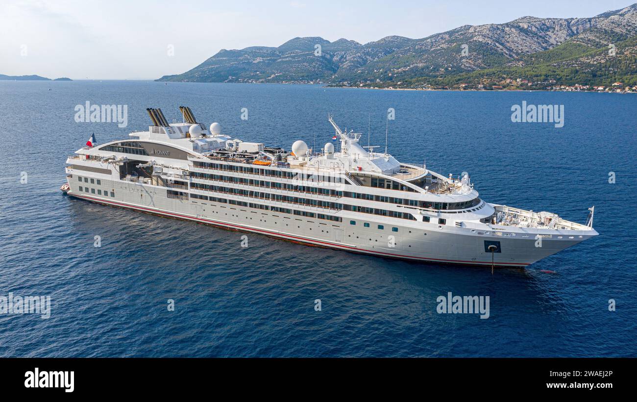 Expedition cruise ship LE LYRIAL anchored in Korcula island & town in Croatia, Adriatic Sea, French luxury cruise line PONANT, Dalmatian coast cruises Stock Photo