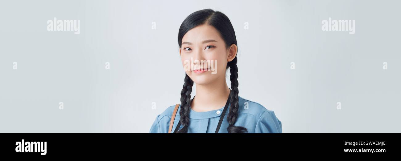 young Asian woman wearing blue dress on white background Stock Photo