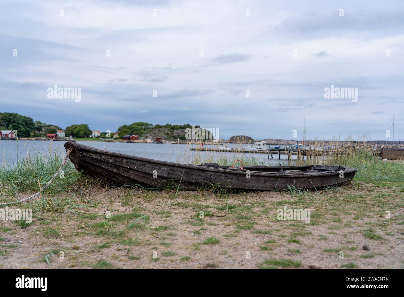 A small vessel rests atop a grassy meadow in Munkkyrkan, Smoegen, Sweden Stock Photo