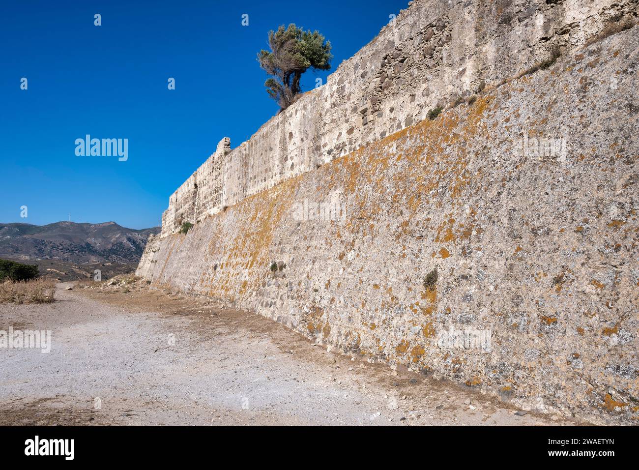 Fortress wall surrounding antimachia castle on kos island, greece. Beautiful clear blue summer sky. Stock Photo