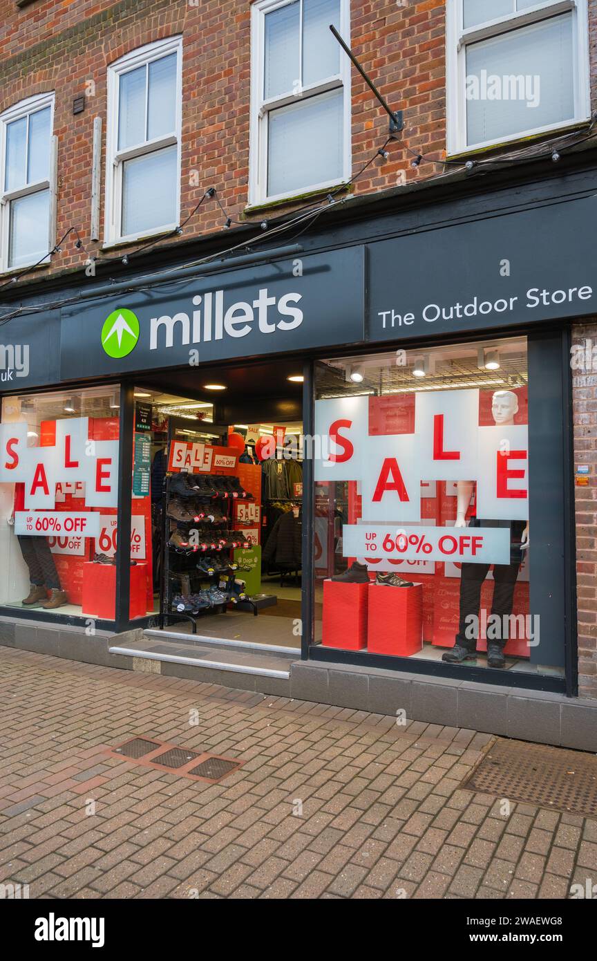 Millets outdoor clothing and equipment shop with sale notices in window advertising cost savings. High Street, Chesham, Buckinghamshire, England, UK Stock Photo