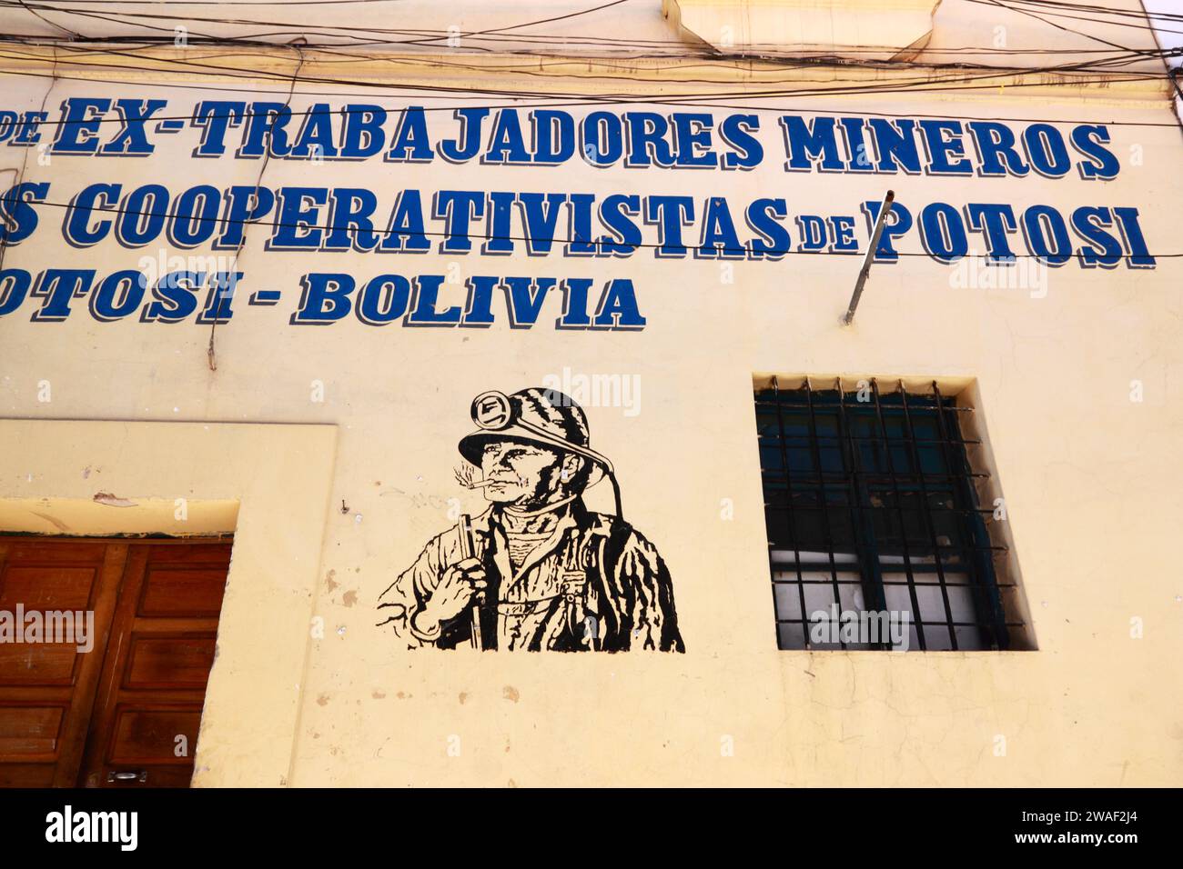 Stencil art portrait of a miner painted on the wall of a retired cooperative mine workers trade union office, Potosi, Bolivia Stock Photo