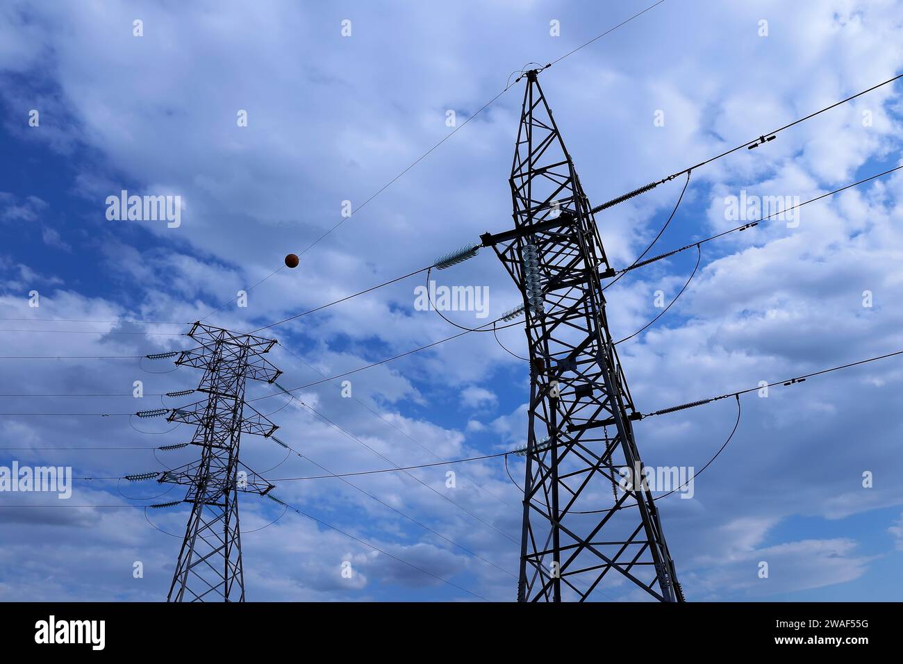 Electric power transmission tower and electrical power cables Stock Photo