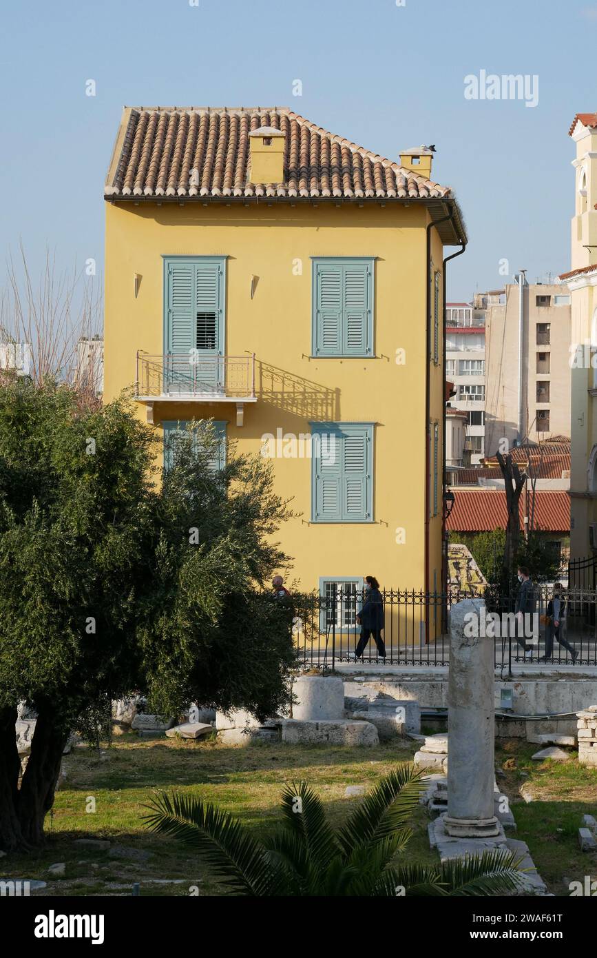 Yellow house in Athen, Plaka, Greece, blue door, blue windows, balcony