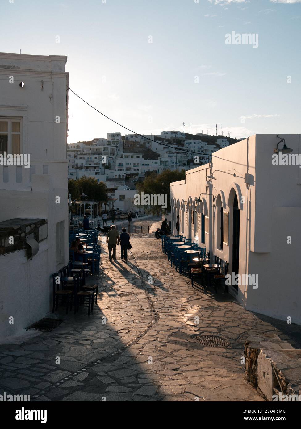 Chora in Astypalea, Island, old couple is going for a walk and holding hands, romantic, sunset, cycladic greek twon, traditional Stock Photo