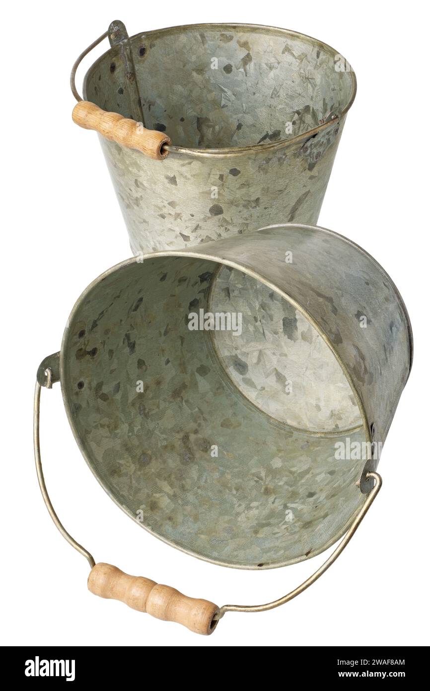 Two empty steel zinc old-fashioned buckets with wooden handles, isolated on white background Stock Photo