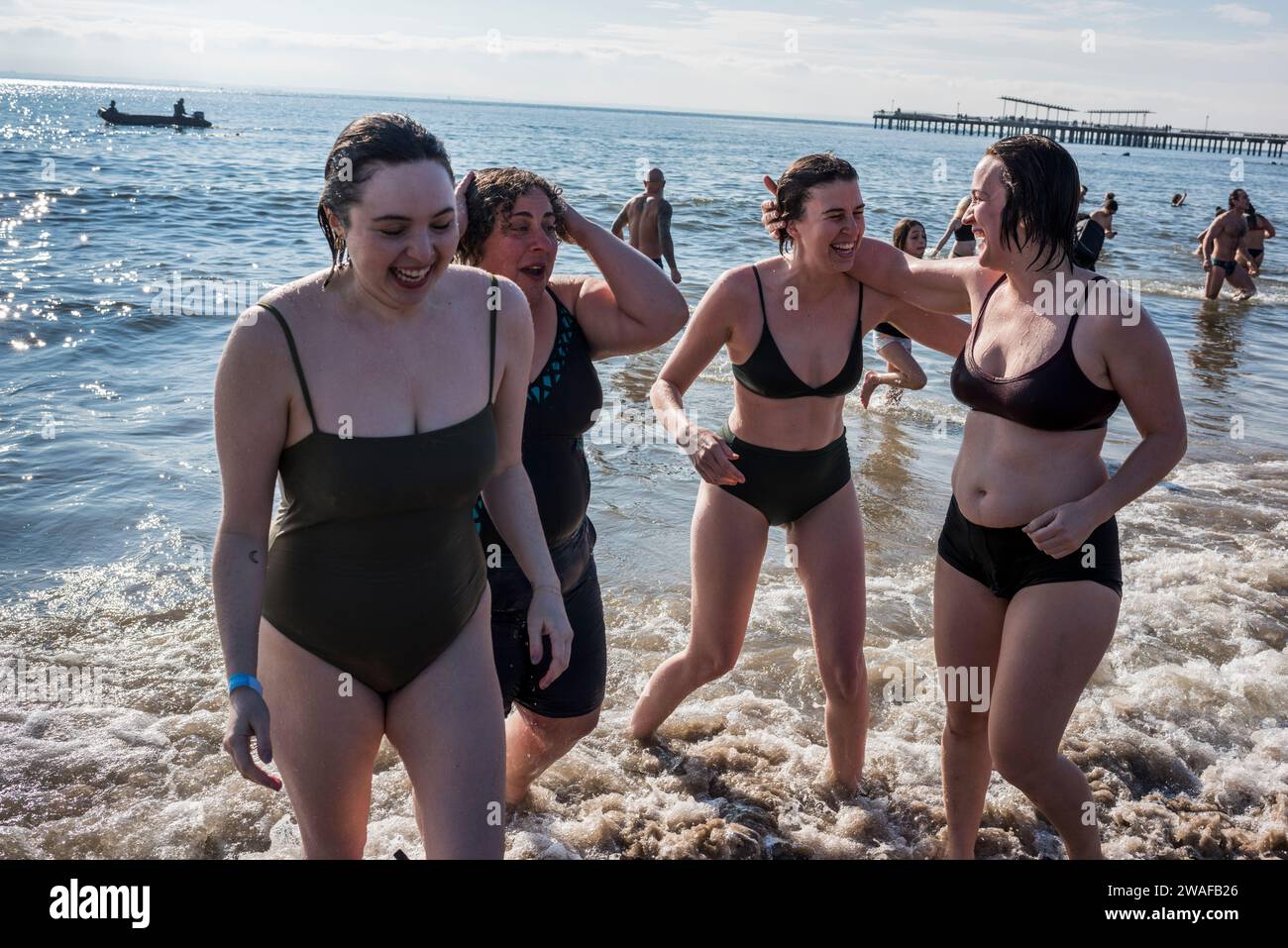 Brooklyn, New York - January 1, 2024: Group running out of the ocean, Coney Island Polar Bear New Years Day Plunge Stock Photo