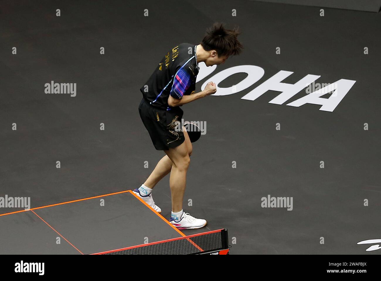 Doha, Qatar. 4th Jan, 2024. Lin Gaoyuan celebrates winning the men's singles quarterfinal