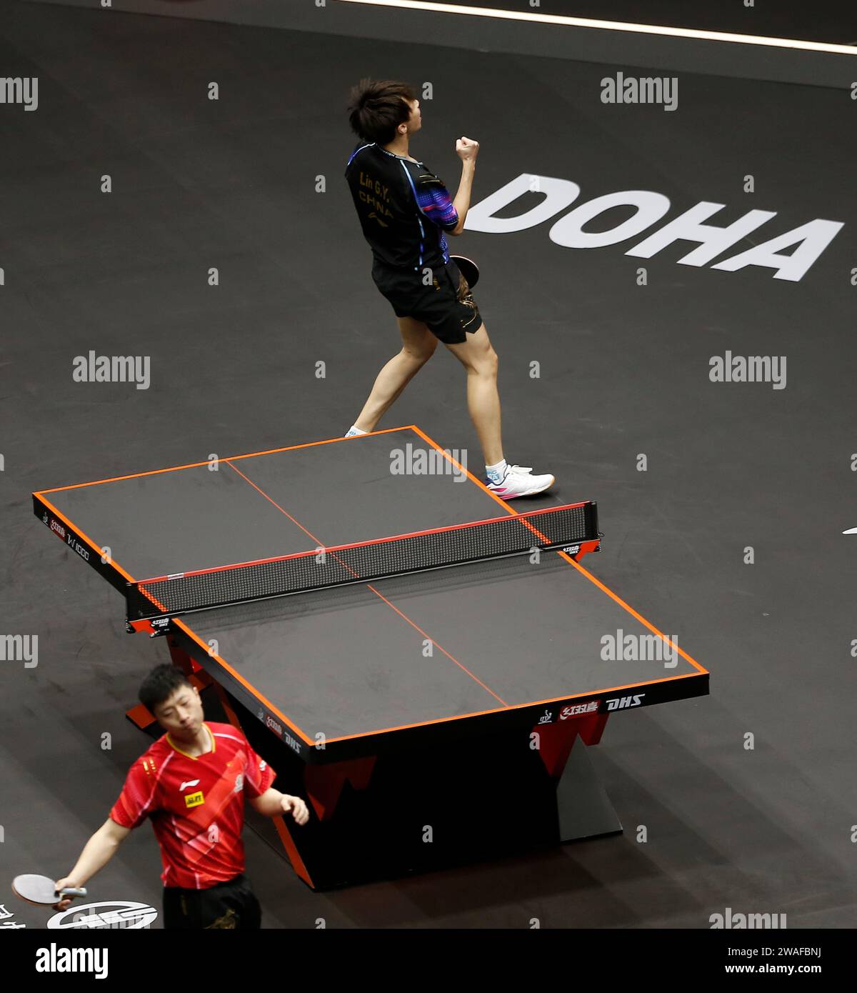 Doha, Qatar. 4th Jan, 2024. Lin Gaoyuan (top) celebrates winning the men's singles quarterfinal