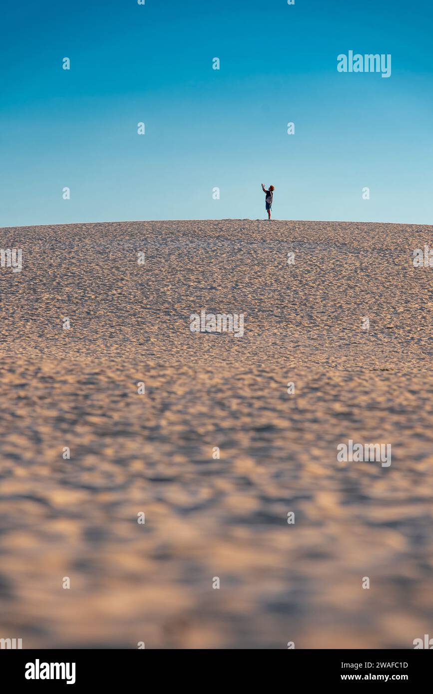 Silhouettes of people on sand dunes on Fuerteventura Stock Photo